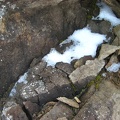 Some rocks along the road make an interesting pattern with the snow.