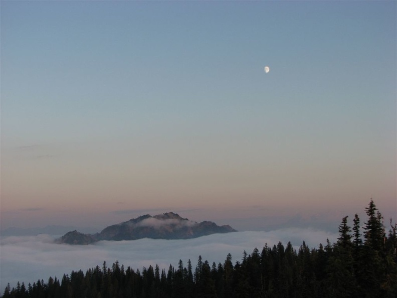 A view to the south showing the almost full moon from Glacier View as the sun sets.