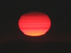 The sun is a ball of fire as it burns through the fog at sunset. This was a most incredible sunset from Glacier View.