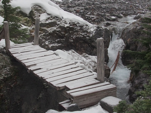 The bridge over Ohanapecosh River looks rickety and slippery after a light dusting of snow.