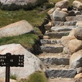 Granite stairs and metal trail sign in Long Meadow in Yosemite National Park.