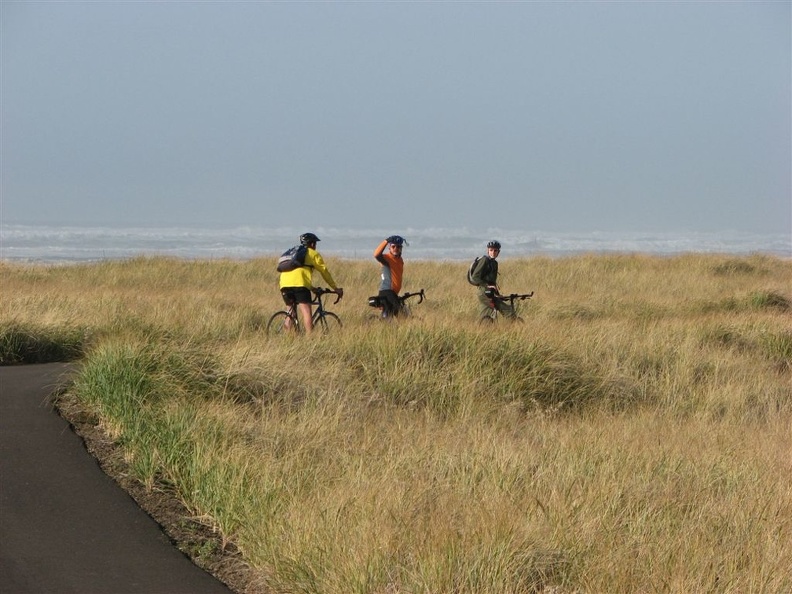 Nicholas, Paul, and Nate on the paved portion of the Lewis and Clark Discovery Trail on the way to Long Beach, WA. The Pacific Ocean is in the background.