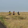 Nicholas, Paul, and Nate on the paved portion of the Lewis and Clark Discovery Trail on the way to Long Beach, WA. The Pacific Ocean is in the background.
