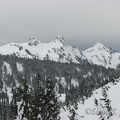 Part of the Tatoosh Range as seen from near Paradise. From left to right, The Castle, Pinnacle Peak, Plummer Peak, Denman Peak.