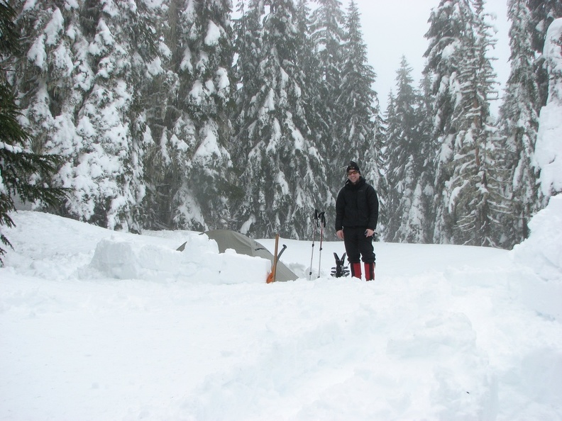 Kevin standing beside his tent after he took some of my snow blocks.