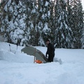 Kevin cuts out a foot well so he can sit in his tent and take his boots off.