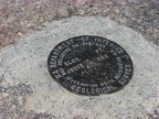 A U.S.G.S. survey monument is set into a rock on the 12,276 foot summit of Mt. Adams.