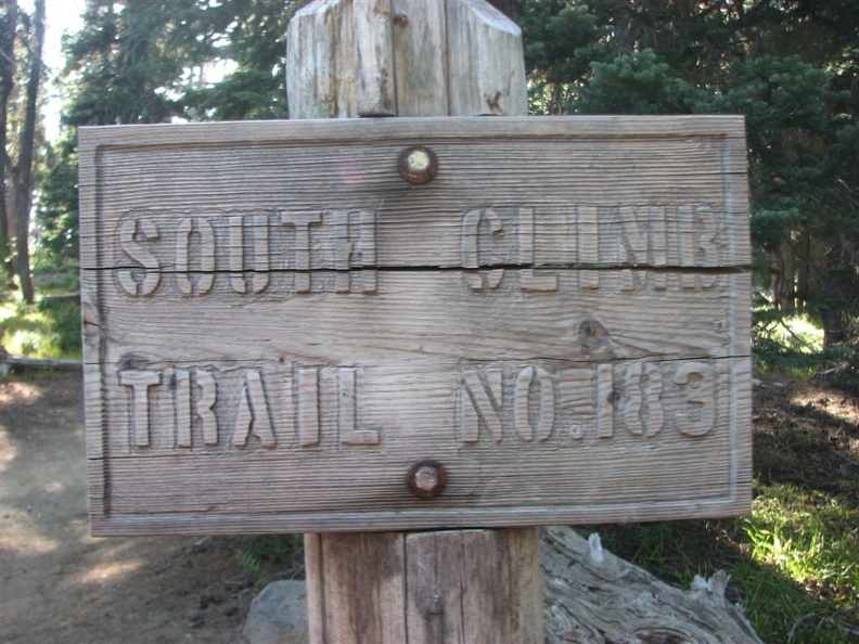 A carved wooden sign at the trailhead shows the beginning of the South Climb Trail 183 to Mt. Adams.