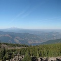 A panoramic view from this great vantage point along the Mt. Defiance Trail shows Mt. Adams and Mt. Rainier on a cloudless day. The only clouds that can be seen are from the contrails of jet planes.