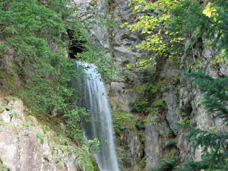 A closeup view of Hole-in-the-Wall Falls showing where the waterfall comes out of the tunnel.