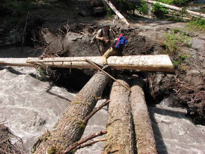 Flood damage along the West Fork of the White River on the Northern Loop Trail where the river has carved a new main channel. Zach is stepping across the old bridge.