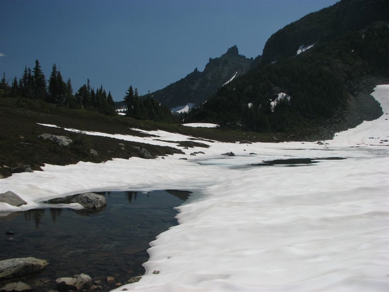 The small lake at Windy Gap is just melting out in mid-July. We filtered water here for the trip down to the Carbon River.