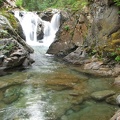 A small waterfall on Chinook Creek near Deer Creek Camp cascades into a clear green pool.