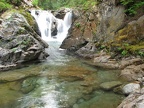 A small waterfall on Chinook Creek near Deer Creek Camp cascades into a clear green pool.