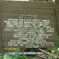 An old Department of Natural Resources sign slowly falls apart just downhill of the trail near where it meets the Pacific Crest Trail.