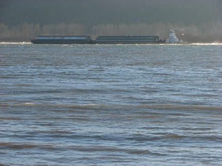 A tugboat pushes a barge against the wind and the current moving cargo upriver as far as Idaho.