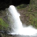Walking under the overhanging cliff at Ponytail Falls on Horsetail Creek in the Columbia River Gorge.