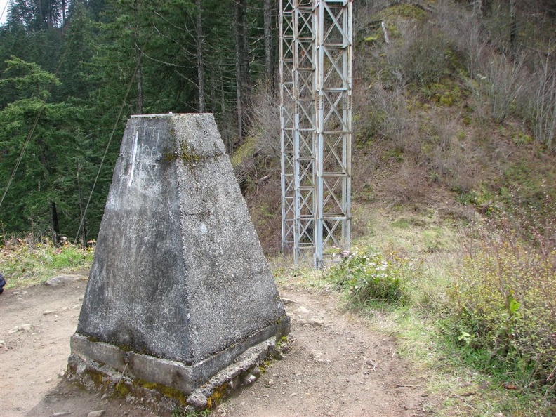 Concrete survey marker and towers for the powerline