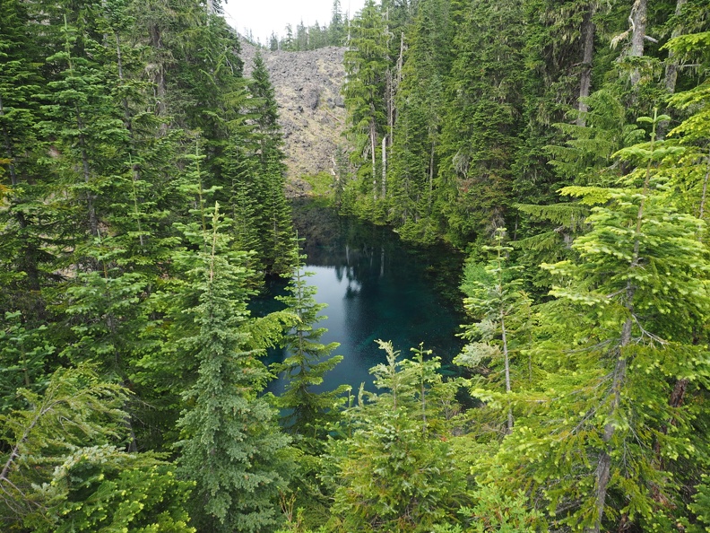 A beautiful emerald pond nestled below the Loowit Trail.