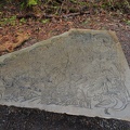 A stone bench near the bridge is almost to nice to sit on.