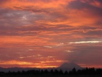 Mt. Rainier from Highway I-5. The mountain is casting a shadow on the clouds at sunrise.