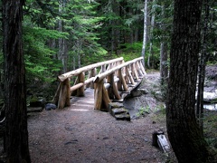 A beautiful cedar bridge spans Van Trump Creek near the trailhead for Comet Falls.