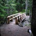 A beautiful cedar bridge spans Van Trump Creek near the trailhead for Comet Falls.