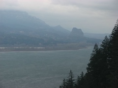 Beacon Rock rises above the Columbia River in the distance to the east. Beacon Rock is in Washington State on the north shore of the Columbia River.