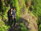 Jeremiah shows a section of the trail that has been blasted out of the cliff and has a railing to hold on to.