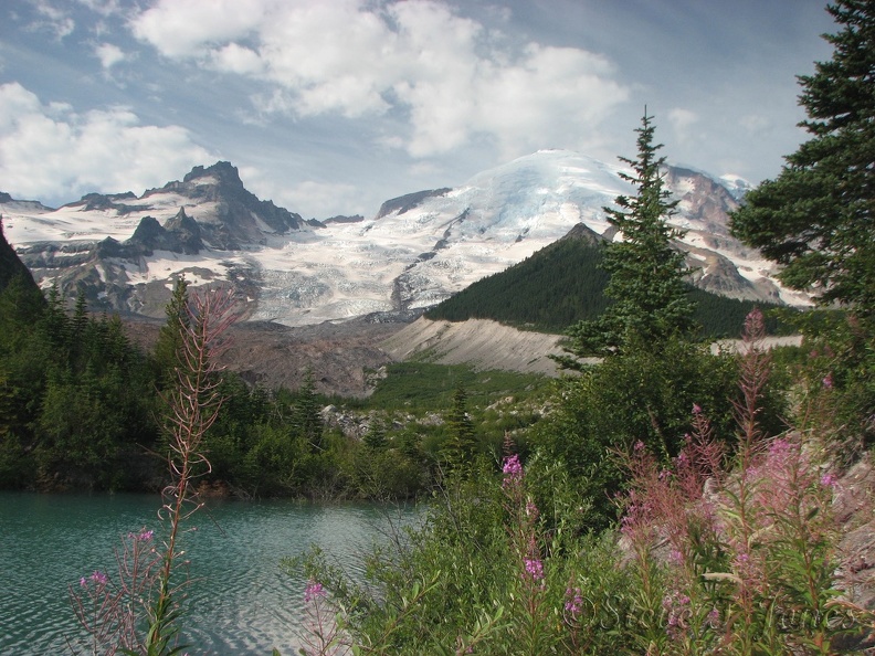 A turquoise lake provides a nice contrast to Mt. Rainier close to the Emmons Glacier View Trail.