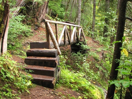 Trail Bridge over the top of a waterfall along the Lewis River Trail.