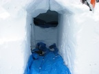 Here is the entrance to my completed igloo. The entrance has one blue tarp and the raised sleeping area has another. I made a cubby hole on the left in the entrance to store gear.