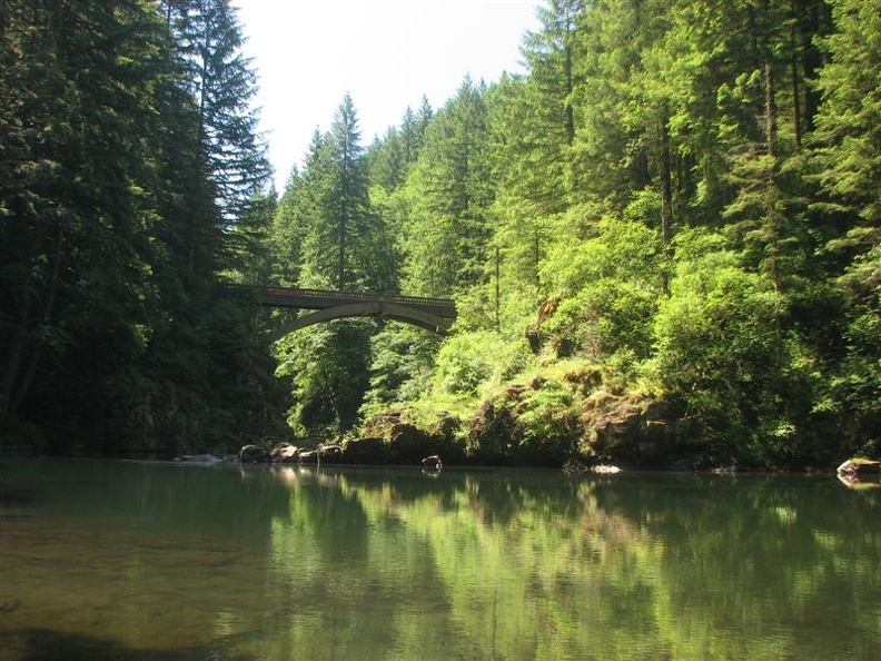 The Moulton Falls Trail crosses the East Fork of the Lewis River on a wood arch bridge.