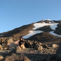 Steve sitting in front of his tent in the morning before climbing to the summit of Mt. Adams. The long rock patch on the right is the easiest way up and down Piker's Peak.