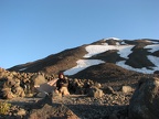 Steve sitting in front of his tent in the morning before climbing to the summit of Mt. Adams. The long rock patch on the right is the easiest way up and down Piker's Peak.