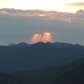 The rising sun pours through two small breaks in the clouds in the east. These clouds later turned into thunderstorms but they never made it to the park.