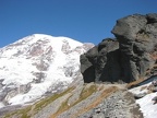 Mt. Rainier and a rock cliff overhanging the Pebble Creek Trail in Mt. Rainier National Park.