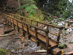 A log bridge spans Ramona Creek just downstream from Ramona Falls, providing a front-row view of the falls.