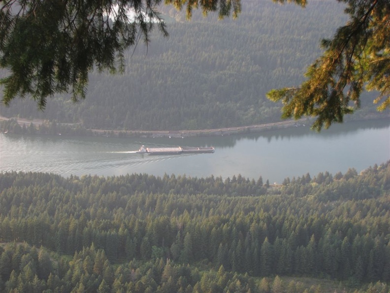 Looking down at a barge going up the Columbia River from the Ruckel Ridge Trail.