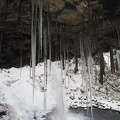 Icicles grow from the overhang behind Ponytail Falls