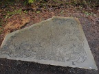 A stone bench near the bridge is almost to nice to sit on.